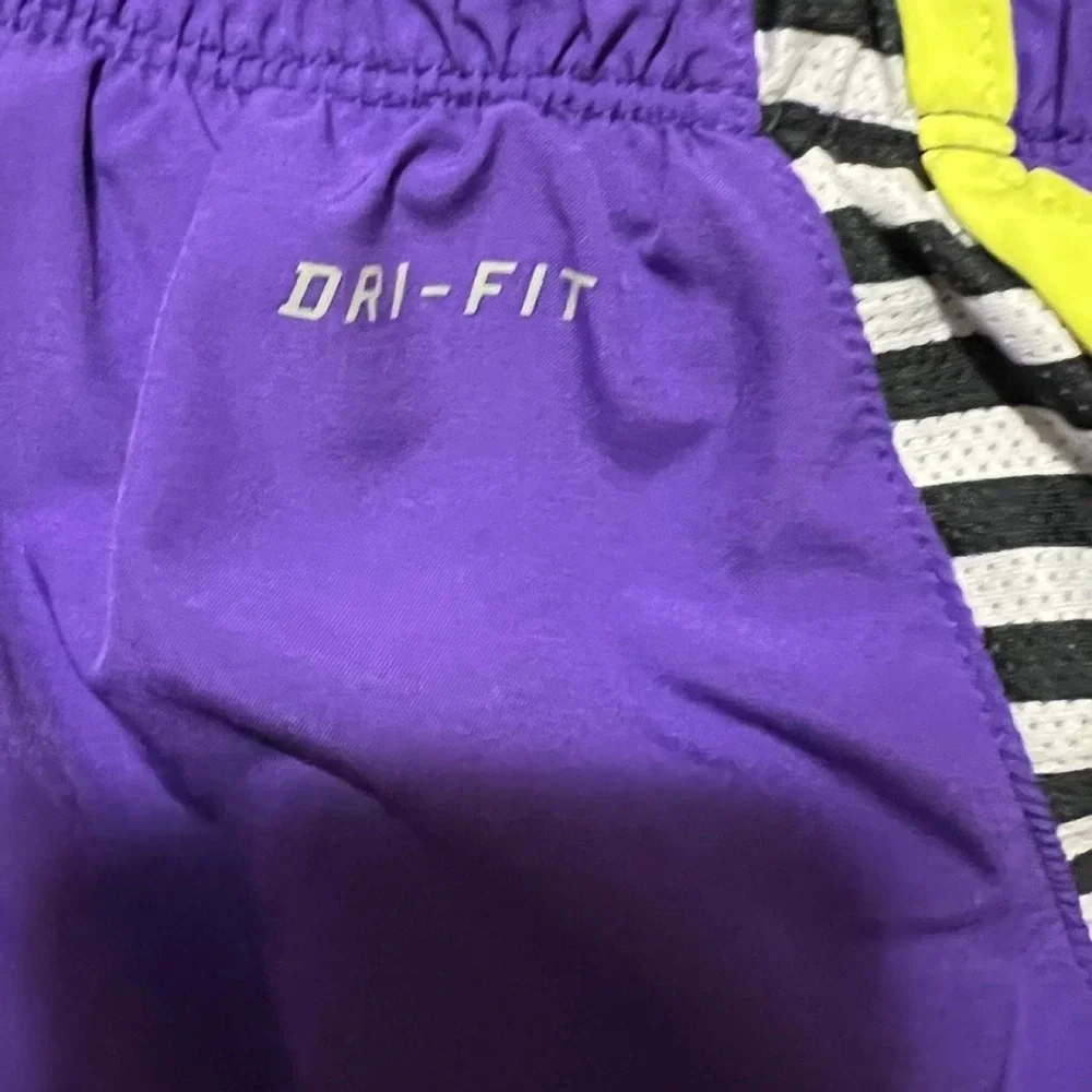Nike Dri-Fit purple shorts with neon yellow trim 311.5